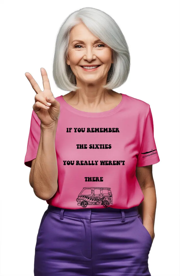 Smiling elderly woman wearing a pink shirt with an empowering message.