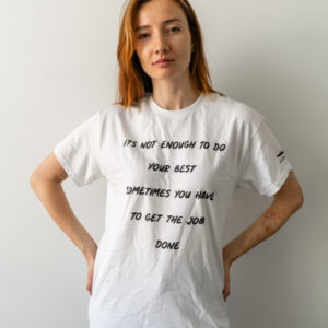 Woman wearing a white t-shirt with a text message.