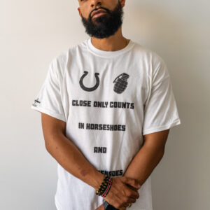 Man wearing a white t-shirt with black text and graphics.