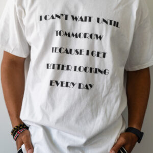 Person wearing a white t-shirt with black text.