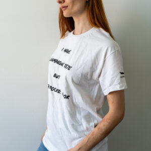 Woman wearing a white graphic t-shirt with text design.