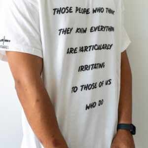 Person wearing a white shirt with a philosophical quote.