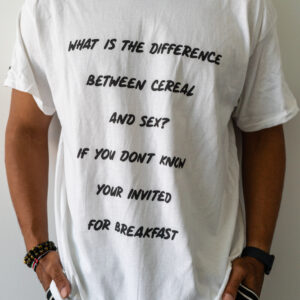 Person wearing a white T-shirt with a humorous text about cereal and soup.