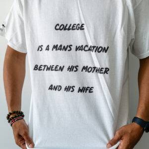 White t-shirt with a humorous college quote in black text.