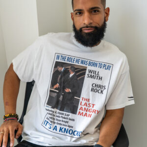 Man wearing a white graphic t-shirt with text and images.